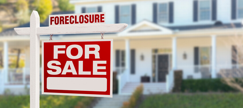 A for-sale sign for a foreclosed listing